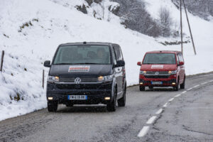 Two ski transfer vans close up driving towards camera