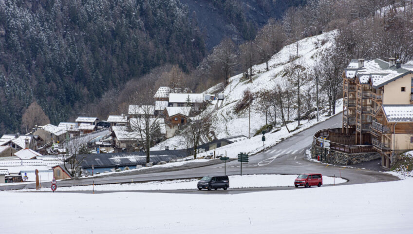 Two ski transfer vans driving up winding mountain road