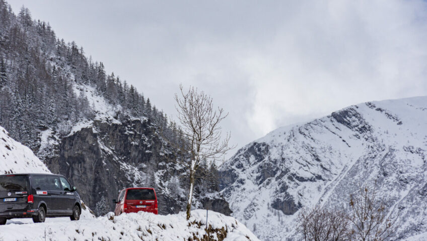 Two vans driving up steel mountain road