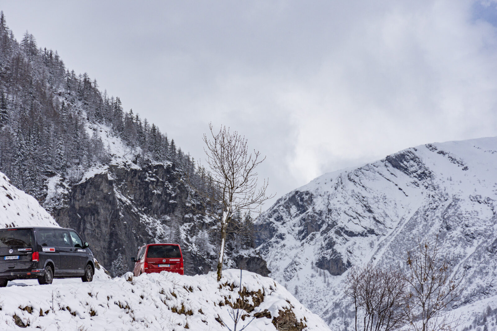 Two vans driving up steel mountain road