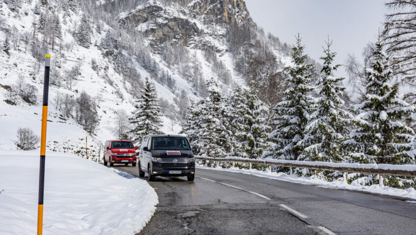 Two vans on alpine winter road