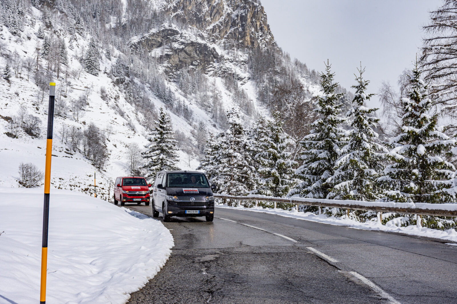 Two vans on alpine winter road