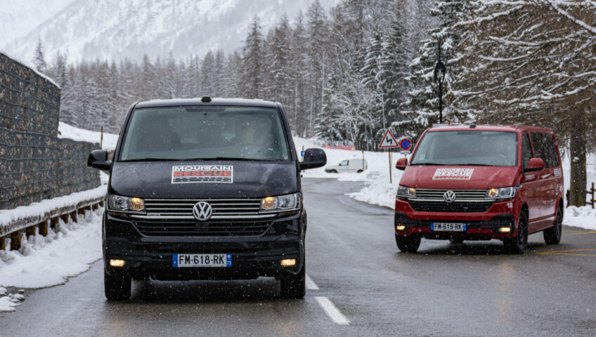 Black and Red Mountain Rescue minibuses on alpine road