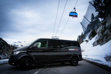 Mountain Rescue Trasnfer van across a road with ski lift behind