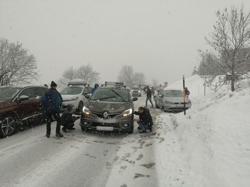 French Alps roads blocked with people putting snow chains on