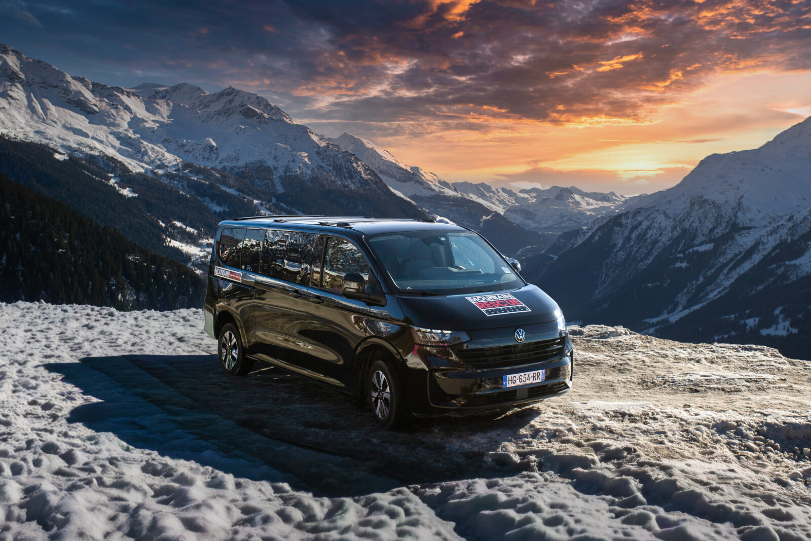 mountain rescue minibus on mountain top with sunset